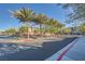 Neighborhood street view featuring mature trees, landscaped greenery, and a glimpse of the community's exterior at 25 Barbara Ln # 42, Las Vegas, NV 89183