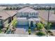 An aerial view of a well-maintained two-story home with a tiled roof and lush green landscaping at 2577 Tolmezzo St, Henderson, NV 89044