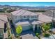 Aerial view of a two-story home with well-maintained landscaping and a tile roof in a residential area at 2577 Tolmezzo St, Henderson, NV 89044