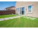 The backyard features green lawn, stepping stones, chairs, and the building's exterior at 2577 Tolmezzo St, Henderson, NV 89044