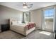 Bright bedroom featuring a ceiling fan, natural light from the window, and neutral carpet at 2577 Tolmezzo St, Henderson, NV 89044