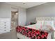 Comfortable bedroom featuring a patterned bedspread and white dresser for ample storage at 2577 Tolmezzo St, Henderson, NV 89044