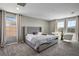 Bright bedroom with an upholstered headboard and large windows at 2577 Tolmezzo St, Henderson, NV 89044