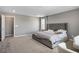 Spacious bedroom with a luxurious upholstered headboard and stylish decor at 2577 Tolmezzo St, Henderson, NV 89044
