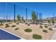 Bright shot of a community park featuring a sand volleyball court, grassy area, and playground on a clear day at 2577 Tolmezzo St, Henderson, NV 89044