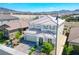 Two-story home with a tile roof, well-manicured landscaping, and a brick driveway at 2577 Tolmezzo St, Henderson, NV 89044