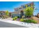 Two-story home boasting a tile roof, green shutters, lush landscaping, and a two-car garage at 2577 Tolmezzo St, Henderson, NV 89044