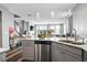 Modern kitchen with sleek appliances, breakfast bar, and an open layout to the living area at 2577 Tolmezzo St, Henderson, NV 89044