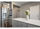 Modern kitchen featuring a stainless steel refrigerator, quartz countertop, and gray cabinetry at 2577 Tolmezzo St, Henderson, NV 89044