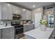 Bright kitchen with gray cabinetry, stainless steel appliances, a large island and lots of counter space at 2577 Tolmezzo St, Henderson, NV 89044