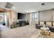 Cozy living room featuring a plush sofa, modern entertainment center, and natural light at 2577 Tolmezzo St, Henderson, NV 89044