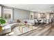 Open-concept living room featuring sleek hardwood flooring, modern furnishings, and a cozy atmosphere at 2577 Tolmezzo St, Henderson, NV 89044