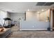 A neutral-toned loft area with plush carpet, ambient lighting, and a cozy seating area perfect for relaxation at 2577 Tolmezzo St, Henderson, NV 89044