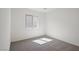 A clean and well-lit bedroom featuring a large window and neutral carpeting at 2618 Lily Point St, Las Vegas, NV 89156