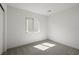 Well-lit bedroom with neutral carpet, a large window, and a view of the white paneled entry door at 2618 Lily Point St, Las Vegas, NV 89156