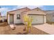 A well-maintained single-story home with a two-car garage, desert landscaping, and a brick driveway at 2618 Lily Point St, Las Vegas, NV 89156