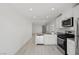 Bright and modern kitchen featuring stainless steel appliances, white cabinets, and light wood floors at 2618 Lily Point St, Las Vegas, NV 89156