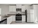 Bright, updated kitchen with stainless steel appliances, granite countertops, and white cabinetry at 2618 Lily Point St, Las Vegas, NV 89156