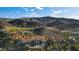 Panoramic aerial showcasing neighborhood homes nestled against a mountain landscape at 30 Via Tiberius Way, Henderson, NV 89011