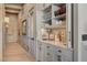 Stylish hallway featuring built-in cabinets, elegant decor, and hardwood flooring throughout at 30 Via Tiberius Way, Henderson, NV 89011