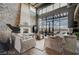 Inviting living room boasting a stone fireplace, soaring windows, and scenic views at 30 Via Tiberius Way, Henderson, NV 89011