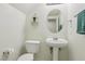 Practical half bathroom featuring a toilet and pedestal sink, perfect for guests at 3320 Indian Moon Dr, Las Vegas, NV 89129