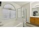 Relaxing bathroom featuring a soaking tub and glass-enclosed shower, with a view from the window at 3320 Indian Moon Dr, Las Vegas, NV 89129