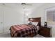 Welcoming bedroom with classic decor, featuring a comfortable bed, soft carpeting, and ample natural light at 3320 Indian Moon Dr, Las Vegas, NV 89129