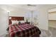 Charming bedroom with warm tones, featuring a comfortable bed, soft carpeting, and ample natural light at 3320 Indian Moon Dr, Las Vegas, NV 89129