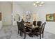 Bright dining room features high ceilings, carpet flooring, and a large wooden dining table with upholstered chairs at 3320 Indian Moon Dr, Las Vegas, NV 89129