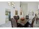 Bright dining room features high ceilings, carpet flooring, and a large wooden dining table with upholstered chairs at 3320 Indian Moon Dr, Las Vegas, NV 89129