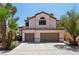 Charming home featuring a tile roof, desert landscaping, and an attached two-car garage at 3320 Indian Moon Dr, Las Vegas, NV 89129