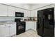 Open concept kitchen featuring white cabinets, granite countertops, and black appliances at 3320 Indian Moon Dr, Las Vegas, NV 89129