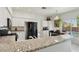 Open concept kitchen featuring white cabinets, granite countertops, and black appliances at 3320 Indian Moon Dr, Las Vegas, NV 89129