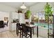Eat-in kitchen with a view of the pool features a dining table and lots of natural light from the large windows at 3320 Indian Moon Dr, Las Vegas, NV 89129