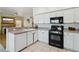Open concept kitchen featuring white cabinets, granite countertops, and black appliances at 3320 Indian Moon Dr, Las Vegas, NV 89129
