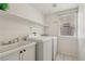 Functional laundry room equipped with a washer, dryer, and sink, offering convenience and efficiency at 3320 Indian Moon Dr, Las Vegas, NV 89129