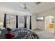 Spacious main bedroom features plush carpet, generous natural light, and en suite bathroom at 3320 Indian Moon Dr, Las Vegas, NV 89129