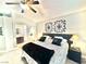 Bedroom featuring a ceiling fan, unique wall decor, and access to the bathroom at 3329 Hidden Ridge St, Las Vegas, NV 89129
