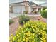 Charming single-story home with well-manicured front yard and colorful flower beds at 3329 Hidden Ridge St, Las Vegas, NV 89129