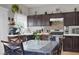 Inviting dining area showcasing a wooden table, dark cabinets, and natural light from the nearby window at 3389 Commendation Dr, Las Vegas, NV 89117