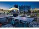 A cozy balcony with outdoor seating offers stunning views of the city skyline at twilight at 360 E Desert Inn Rd # 407, Las Vegas, NV 89109