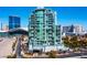 Modern high-rise condominium building with sleek architecture and surrounding landscaping in an urban setting at 360 E Desert Inn Rd # 407, Las Vegas, NV 89109