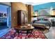 Stylish bedroom features a luxurious bed, wooden furniture, and balcony access with city views at 360 E Desert Inn Rd # 407, Las Vegas, NV 89109