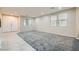 Large living area boasts new gray carpeting, tiled entry, and abundant natural light from sizable windows at 3605 Sapphire Sea Ct, North Las Vegas, NV 89031