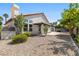 Backyard view of a stucco home with desert landscaping and a covered patio at 4324 Peaceful Path Ct, North Las Vegas, NV 89032