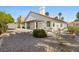 Backyard view with stucco home, desert landscape, and a covered patio at 4324 Peaceful Path Ct, North Las Vegas, NV 89032