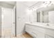 Bright bathroom showcasing double sinks and a large mirror at 4324 Peaceful Path Ct, North Las Vegas, NV 89032