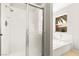 Bathroom featuring tiled shower and tub with a large window at 4324 Peaceful Path Ct, North Las Vegas, NV 89032