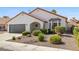 Charming single-story home featuring a well-manicured front yard and a two-car garage at 4324 Peaceful Path Ct, North Las Vegas, NV 89032